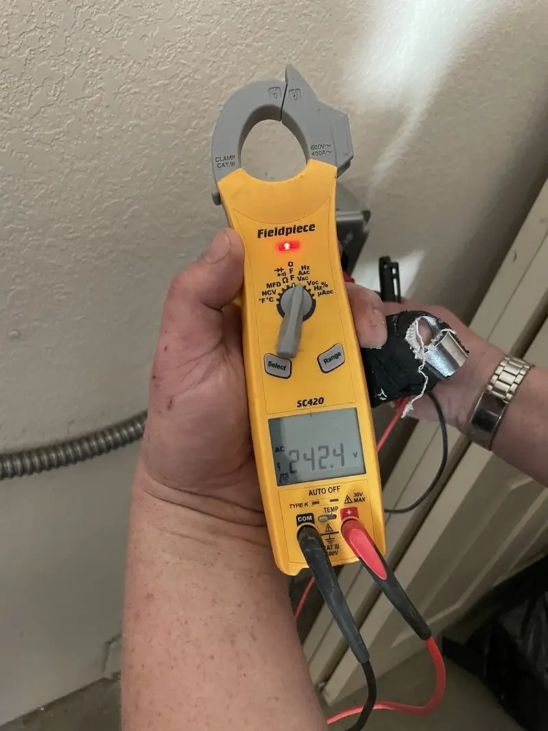 Voltage testing with clamp meter during Generator Installation in Pine Island